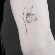 a single flower tattoo on the ankle