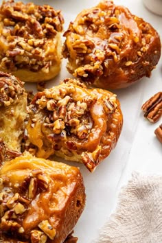 several cinnamon buns with pecans and nuts on top