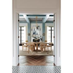 the dining room is decorated in blue and white with geometric patterns on the flooring