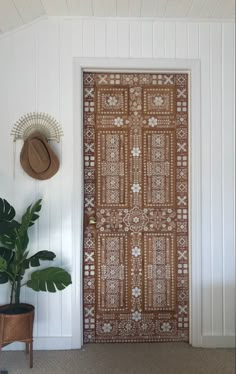 the door is decorated with an intricate pattern and has a hat on it's head