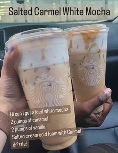 two cups of iced coffee sitting on top of a car dashboard with the words salted caramel white mocha