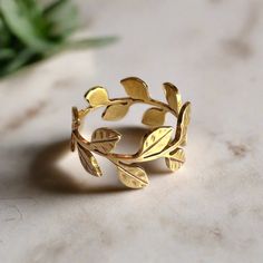 Behold the exquisite craftsmanship of the ‘Eternal Vine’ ring, where elegance meets a touch of whimsy. Crafted with meticulous care, this ring embodies the essence of nature’s eternal beauty. The delicate vine design, adorned with meticulously hammered leaf details, wraps gracefully around the entire band, symbolizing the timeless cycle of growth and renewal. Each ‘Eternal Vine’ ring is a unique masterpiece, meticulously cut and shaped with a jeweler’s saw. The warm glow of 14k gold filled or th Elegant Hand Forged Rings, Elegant Hand Forged Open Ring Jewelry, Elegant Stackable Rings In Recycled Gold As A Gift, Delicate Recycled Gold Ring Jewelry, Elegant Recycled White Gold Stackable Rings, Elegant White Gold Stackable Rings From Recycled Gold, Elegant Hand Forged White Gold Rings, Elegant White Gold Stackable Rings In Recycled Gold, Delicate Hand Forged Wedding Rings