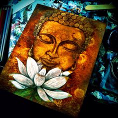 a painting with a white flower in front of it and a buddha's face on the side