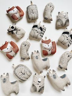 many small animal ornaments are arranged on a white surface