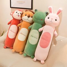 four stuffed animals sitting on top of a bed