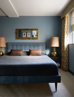 a large bed sitting in a bedroom next to two lamps on either side of it