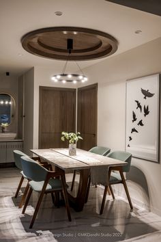 a dining room table with blue chairs around it