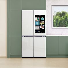 a white refrigerator freezer sitting inside of a kitchen next to a green counter top