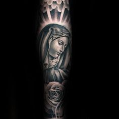 a black and white tattoo on the arm of a woman with a rose in her hand