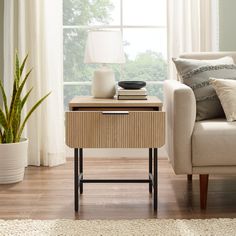 a living room scene with focus on the end table and chair next to the couch