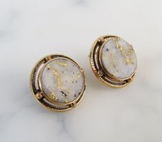 "The simple 14k yellow gold bezel-settings showcase the round gold-in-quartz stones within these antique 1910s earrings. Black enamel rings and textured spheres frame the stones nicely. Gold-Bearing Quartz is one of the world's rarest forms of natural gold. It is found underground by hard rock miners in only a few locations in the world. The natural veins of pure gold were formed in quartz by hydrothermal pressure deep within the earth millions of years ago. The flat polished gems are of white t Enamel Rings, Natural Gold, Enamel Ring, Earrings Black, Gold Enamel, Pure Gold, Quartz Stone, Black Enamel, Jewelry Earrings Studs