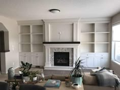 a living room filled with furniture and a fire place in the middle of a room