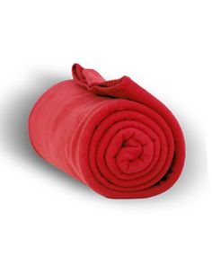 the red blanket is rolled up and ready to be used as a bedding material