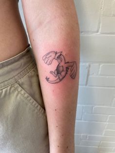 a woman's arm with a tattoo on it that has a bird flying through the air