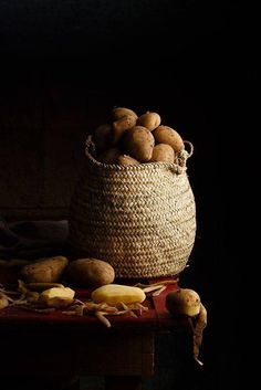 a basket filled with potatoes sitting on top of a table