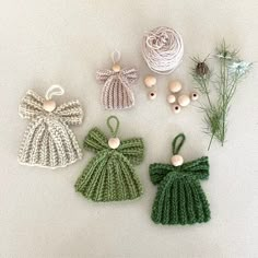 crocheted ornaments are displayed on a white surface with twine and pine needles