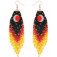 a pair of earrings with beaded designs on the front and back of each ear