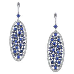 Oval long dangle earrings with round Blue Sapphires and pave white brilliant cut diamonds handcrafted in 18Kt white gold. This breathtaking piar of earrings speaks volumes as it glimmers with natural brilliance. The Blue Sapphires captures the power of attraction while the diamonds iluminate the earrings. This jewelry piece belongs to Metalloplasies Collection, fragments of creativity, representing all different paths Nicofilimon has walked on during his career. A romantic jewelry piece, guarant Luxury Platinum Blue Earrings, Luxury Blue Platinum Earrings, Blue Diamond Earrings With Pave Setting, White Gold Sapphire Earrings With Pave Setting, Silver Sapphire Earrings With Pave Setting, Blue Sterling Silver Earrings With Pave Setting, Blue Cubic Zirconia Earrings With Pave Setting, Sapphire Earring, Stunning Aesthetic