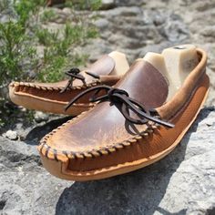 "This men's plain toe canoe moccasin is made with our tan distressed toe plug and collar and our new pebble grain copper caprice vamp. This moccasin has the unique look of the tan distressed leather with the softness of the copper caprice. The tan distressed leather is a firm more substantial leather, and has unique coloring which shows natural characteristics and can vary from one moccasin to another. The copper caprice is a soft pebble grain leather that will easily conform to the shape of you Rugged Moccasins With Stitched Sole, Rugged Moc Toe Moccasins For Outdoor, Brown Slip-on Moccasins With Textured Sole, Rugged Moccasins With Stitched Sole And Moc Toe, Leather Moccasins With Vibram Sole, Rugged Brown Slip-on Loafers, Brown Moc Toe Loafers For Outdoor, Rugged Leather Moccasins With Plain Toe, Rugged Leather Moc Toe Loafers