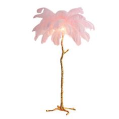 a pink feather lamp on a gold stand against a white background with the light turned on