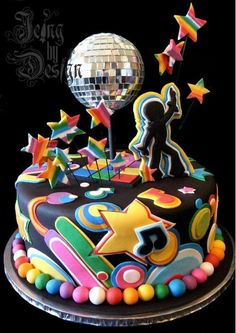 a birthday cake with the number 705 on it and colorful decorations, including a disco ball