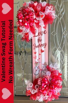 a valentine's day door hanger decorated with red and white ribbon, pink flowers and hearts