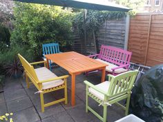 an outdoor table and chairs are painted in different colors