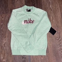 Nike Brand Light Green Heather, Pullover Sweatshirt, Kangaroo Front Pocket, Cotton Rayon Polyester Blend Nike Crew Neck T-shirt For Fall, Nike Long Sleeve Cotton Sweatshirt, Nike Cotton Long Sleeve Sweatshirt, Nike Green Fleece Tops, Green Crew Neck Sweatshirt For School, Nike Green Crew Neck Sweatshirt, School Fleece Tops With Letter Print, Nike Letter Print Top For Winter, Nike Cotton Sweatshirt With Graphic Print