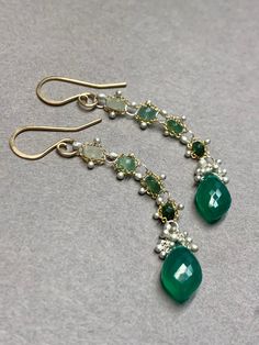 Woven faceted 3mm emeralds with faceted Green Onyx Marquise Briolettes are light weight and fluid.  Our woven earrings are handcrafted and thoughtfully designed to add movement and color that showcase these gemstones and you. *Rare stone setting by torching gems securely into place. *Unique metalwork of kinetic granulation resembling caviar (tiny silver balls torched into place) *Sturdy yet delicate *Rubber backs are included for you to keep them securely on your ears. Understated elegance.  The Elegant Green Briolette Jewelry, Elegant Emerald Gemstones For Jewelry Making, Elegant Green Briolette Gemstones, Green Fusion Style Drop Earrings, Multi-stone Emerald Earrings For Gift, Emerald Multi-stone Earrings For Gift, Elegant Green Onyx Gemstone Jewelry, Emerald Multi-stone Jewelry For May Birthstone, Elegant Green Onyx Jewelry For May Birthstone