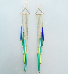 These earrings are inspired by the beautiful vintage bugle beads. The colors are amazing from the shades of blue and green. Brass chain, little African beads between the strands of chain. The ear wires are handmade, 14K gold filled, 20Ga, lever backs. The longest dangle is 110mm, the shortest is 60mm. I have more colors of these beads and the length can be adjusted if you like. ~Thank you for stopping by and supporting handmade, have a lovely day~ ~KR :) Tube Bead Jewelry, Tube Bead Earrings, Bugle Beads Earrings, Bugle Bead Jewelry, Bugle Bead Earrings, Wire Jigs, Beads Magic, Diy Earrings Easy, Beaded Chandelier Earrings