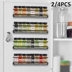 an open refrigerator door with spices and condiments on the shelves next to it