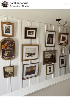 there are many framed pictures on the wall