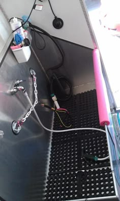 the inside of a vehicle with wires and other electrical equipment on the floor next to it