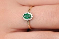 "Emerald Ring / 14k Classic Oval Cut Emerald Ring with Surrounding Diamonds / Natural Emerald Ring in 14k Solid Gold / Mothers Day Gift * If you would like to see the Matching Earrings Please Click Below https://www.etsy.com/listing/604292239/emerald-earrings-14k-oval-cut-emerald?ref=related-4 * If you would like to see the Matching Necklace Please click Below https://www.etsy.com/listing/590436480/emerald-necklace-14k-classic-oval-cut?ref=related-1 Item Features * Made to Order. * Gold KT: 14K Dainty Oval Diamond Rings, 14k Gold Emerald Ring With Halo Detail, Fine Jewelry 14k Gold Emerald Ring With Halo, Oval Emerald Ring With Halo For Promise, 14k Yellow Gold Cluster Ring With Oval Shape, Oval Yellow Gold Emerald Ring With Halo, Yellow Gold Oval Halo Rings, Elegant Oval Rings Stamped 14k, Dainty Oval Halo Rings