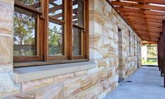 an outside view of a stone building with windows