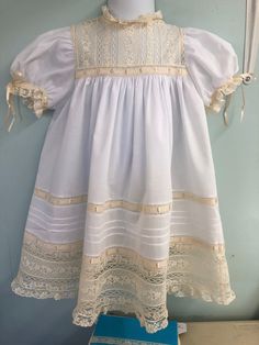 All lace yoke with wide lace skirt band, tucks and ruffle. If you do not have beauty pins you will need to let me know . This will come with a matching slip.