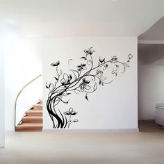 the wall is decorated with black and white flowers, leaves and swirls on it