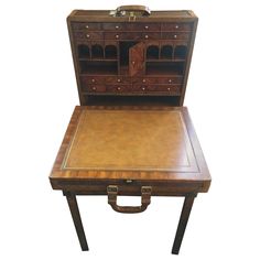 an antique wooden desk with leather top and drawers on the bottom, sitting in front of a white background