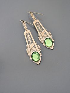 "Vintage Jewelry - Art Deco Inspired Earrings - Crystal Earrings - Bridal Earrings - Gold Earrings - Green Earrings - handmade Jewelry So gorgeous! Awesome Art Deco inspired earrings embellished with three sparkling green vintage crystals. Gold plated. Would be perfect for your wedding. Chloe says, \"Wear them and feel fabulous!\" They measure just over 2 1/2\" long. Thanks for visiting Chloe's" Art Deco Hallmarked Earrings As Gift, Art Deco Dangle Pierced Earrings, Unique Green Pierced Earrings, Art Deco Jewelry As Gift, Art Deco Green Jewelry For Pierced Ears, Art Deco Hallmarked Drop Earrings, Formal Green Nickel-free Earrings, Art Nouveau Dangle Earrings Gift, Art Nouveau Dangle Earrings For Gifts