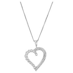 Fall in love with the exquisite Geraldo 1.34 Carat Diamond White Gold Heart Pendant, a true masterpiece of jewelry design. This pendant features a seamless, heart-shaped design, expertly crafted with half of the pendant invisibly set to create a surface that allows the diamonds to shine brilliantly, and the other half in a classic pavé setting to add extra sparkle and dimension to the piece. Crafted from the finest 18-carat white gold, this pendant boasts a flawless finish that enhances its radiance, ensuring that it catches everyone's attention. The diamonds used are of the highest quality, with an F/VS-VVS grade, ensuring unmatched brilliance and beauty. This timeless piece is perfect for any occasion, whether worn as a gift for a loved one, a symbol of self-love, or as a statement acces Gold Heart Pendant, Heart Pendant Gold, The Other Half, Heart Pendant Diamond, Gold Heart, Diamond Heart, Heart Of Gold, To Shine, Diamond White