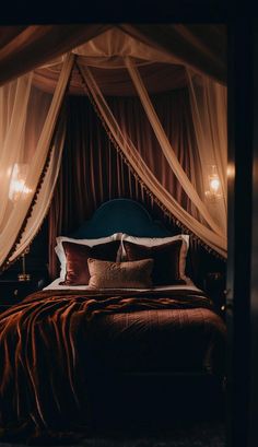 a bed that has some curtains over it and pillows on top of the bedspread