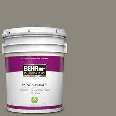 a bucket of behr paint and primer in one on a light blue background