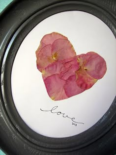 two pink flowers in a black frame with the word love written on it and a handwritten message underneath