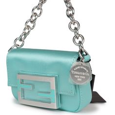 This Fendi x Tiffany Nano Baguette Charm is in tiffany blue silk and leather with sterling silver hardware, front flap snap closure, and Tiffany sterling silver charm.The interior is lined in tiffany blue fabric with one slip pocket.Origin: ItalyCondition: New and never worn Accompanied by: Fendi box, dustbag, carebook and retail UPCMeasurements: 4.5" width x 2.5" height x .5" depth; 3" strap Black Tweed, Evening Handbag, Madison Avenue, Baguette Bag, Bag Light, Tiffany Blue, Blue Silk, Hermes Bags, Sterling Silver Charm