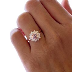 a woman's hand with a diamond ring on it