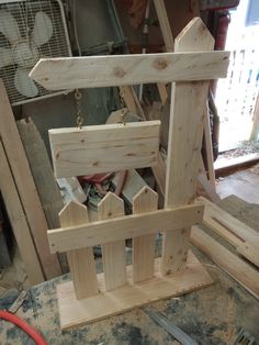 a wooden birdhouse with chains hanging from it's sides and wood sidings