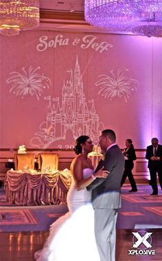 a bride and groom dance together in front of a backdrop that says sofia e star