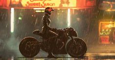 a man riding on the back of a motorcycle in the rain