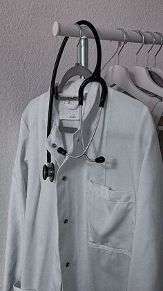 a doctor's coat and stethoscope hanging on a clothes hanger