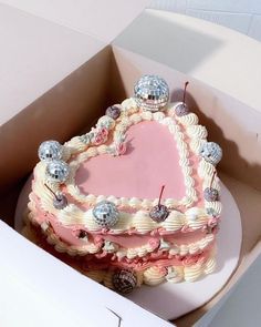 a pink heart shaped cake in a box